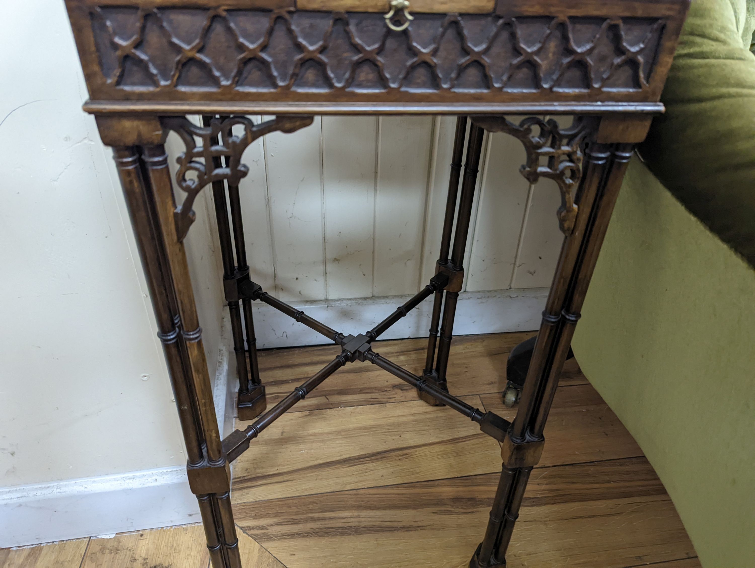 A pair of George III style square mahogany fret cut urn stands on cluster column legs, (one in need of repair) width 34cm, height 72cm